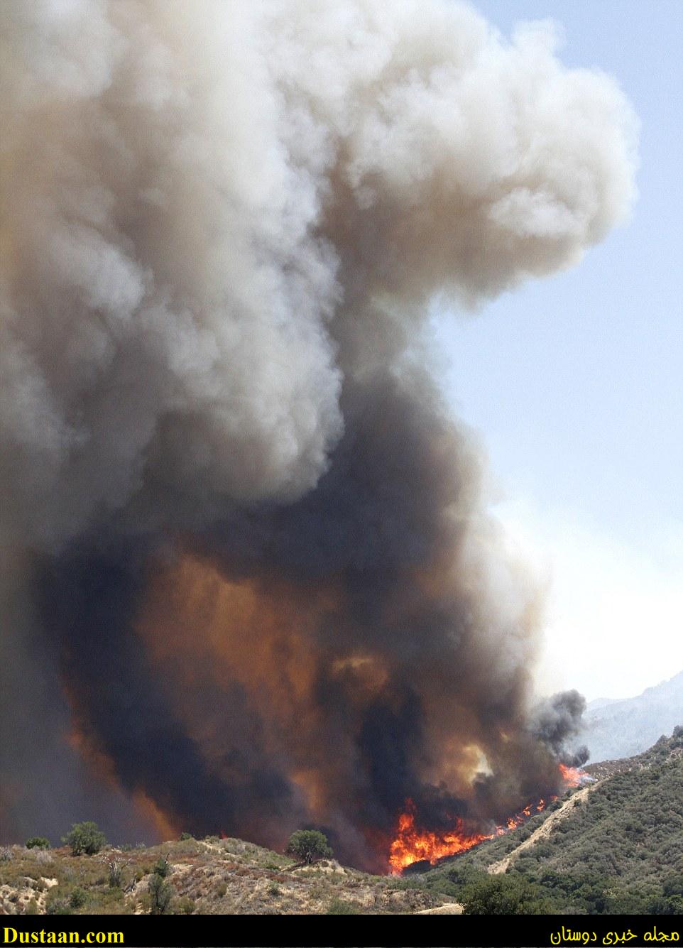 A huge plume of smoke is seen rising into the air next to East Walker Ranch in Santa Clarita, California 