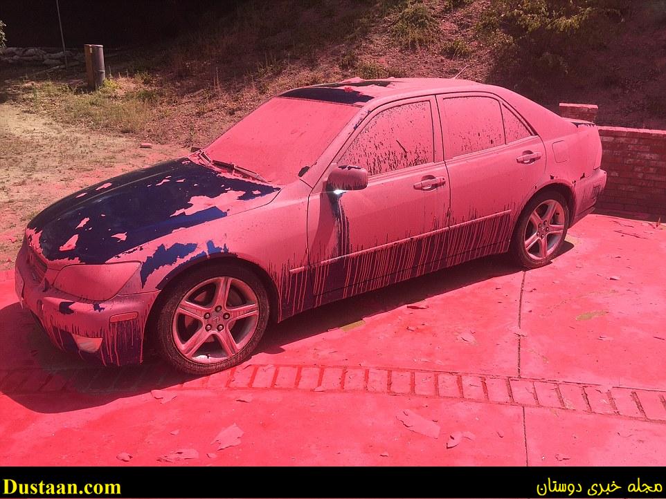Clean-up begins: A car covered in aerially-applied fire retardant remains parked in Ruthspring Drive, in Santa Clarita