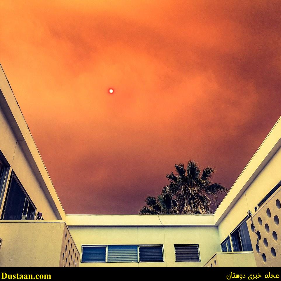 The Los Angeles basin is usually known as a sun-filled area in the summer, but due to the fires, smoke and ash is covering much of the populated city. Above the red, orange and gray colored sky is scene in Los Angeles, as the sun tries to peak through and shine