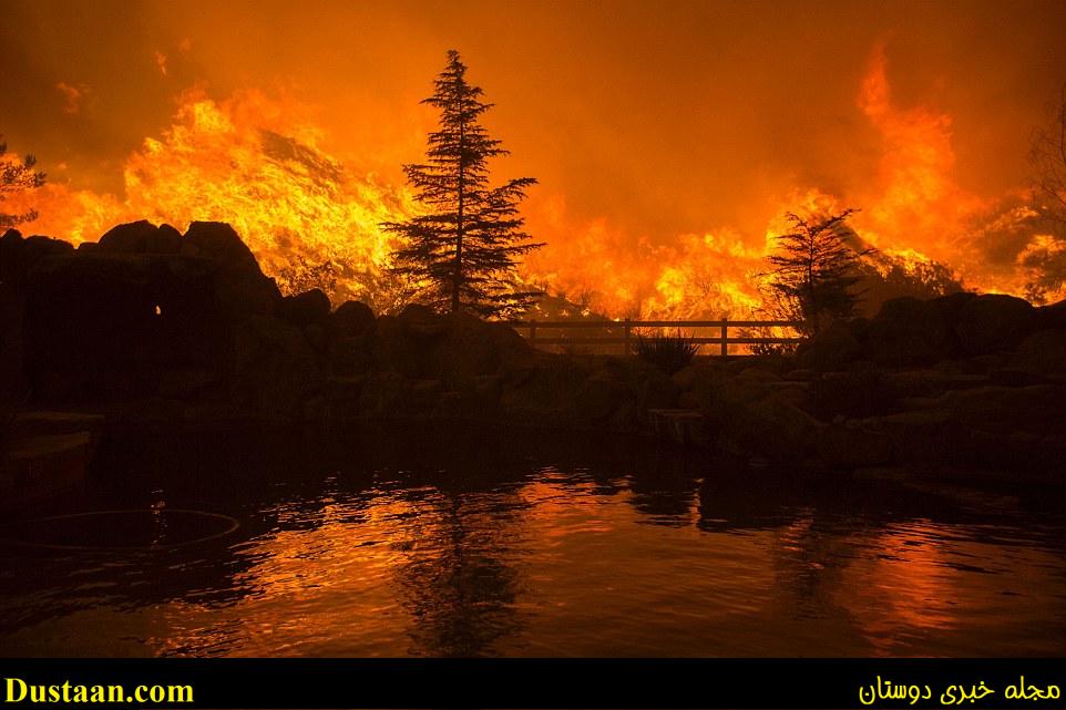 Authorities advised residents to keep their windows and doors closed, as wildfires increase the particulate matter in the air. Above Sand Fire flames are reflected in a backyard swimming pool on Saturday