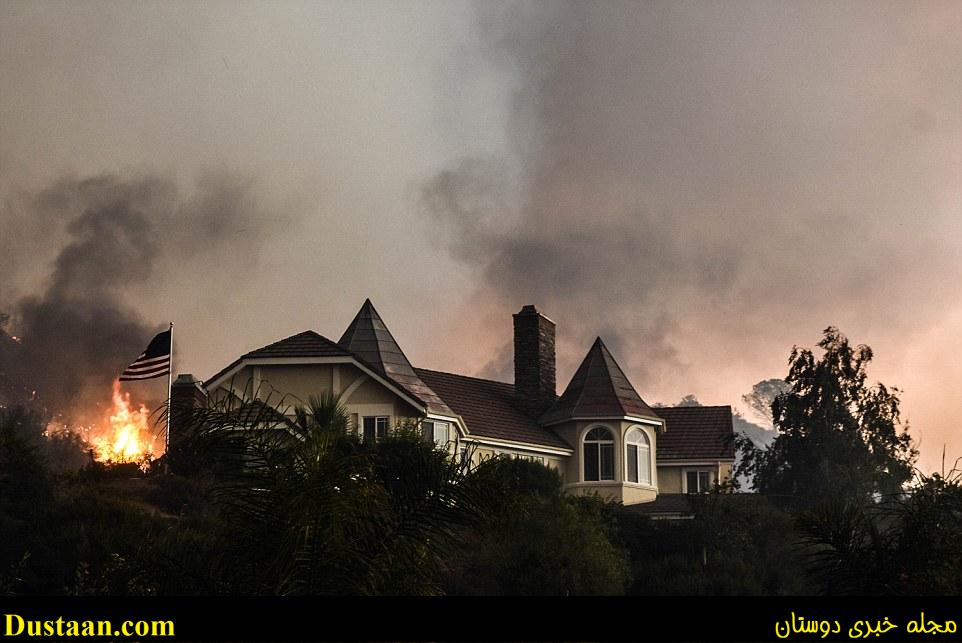 The wildfire is pictured above burning near this luxurious home near Sand Canyon and Placerita Canyon in Santa Clarita on Saturday