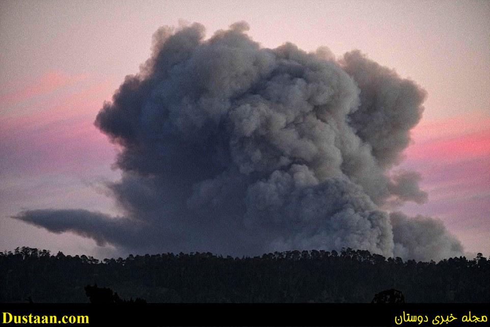 A large plume of smoke from a wildfire rises near Highway 1, burning five miles south of Carmel, California on Friday