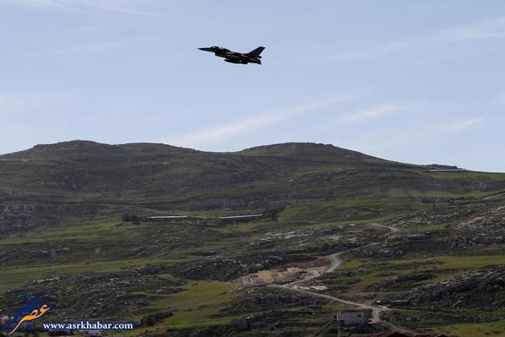 A plane belonging to the Jordanian Royal Air Force flies over the headquarters of the family clan of pilot Kasaesbeh in Karak